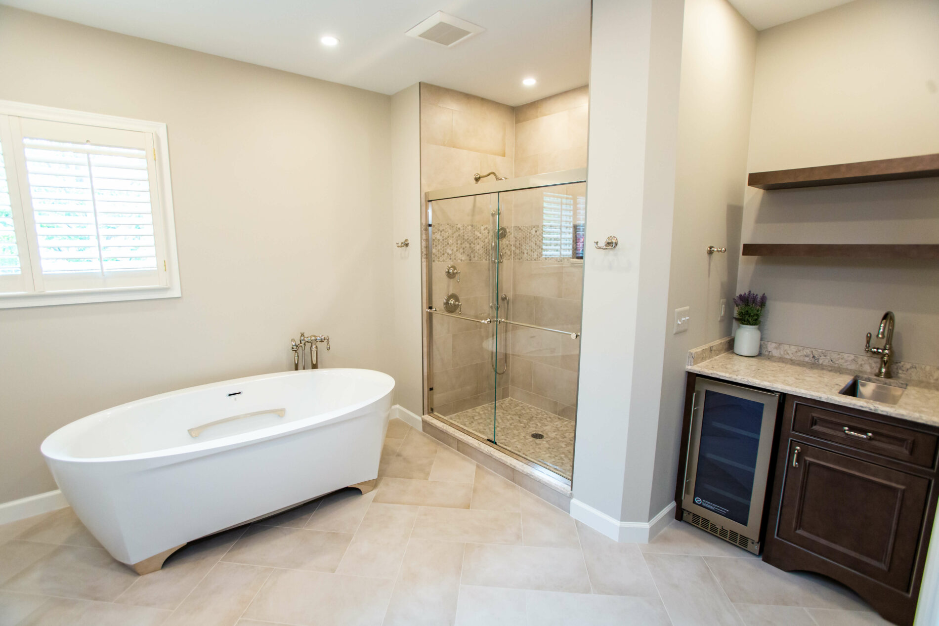 A bathroom with a large tub and sliding door shower.