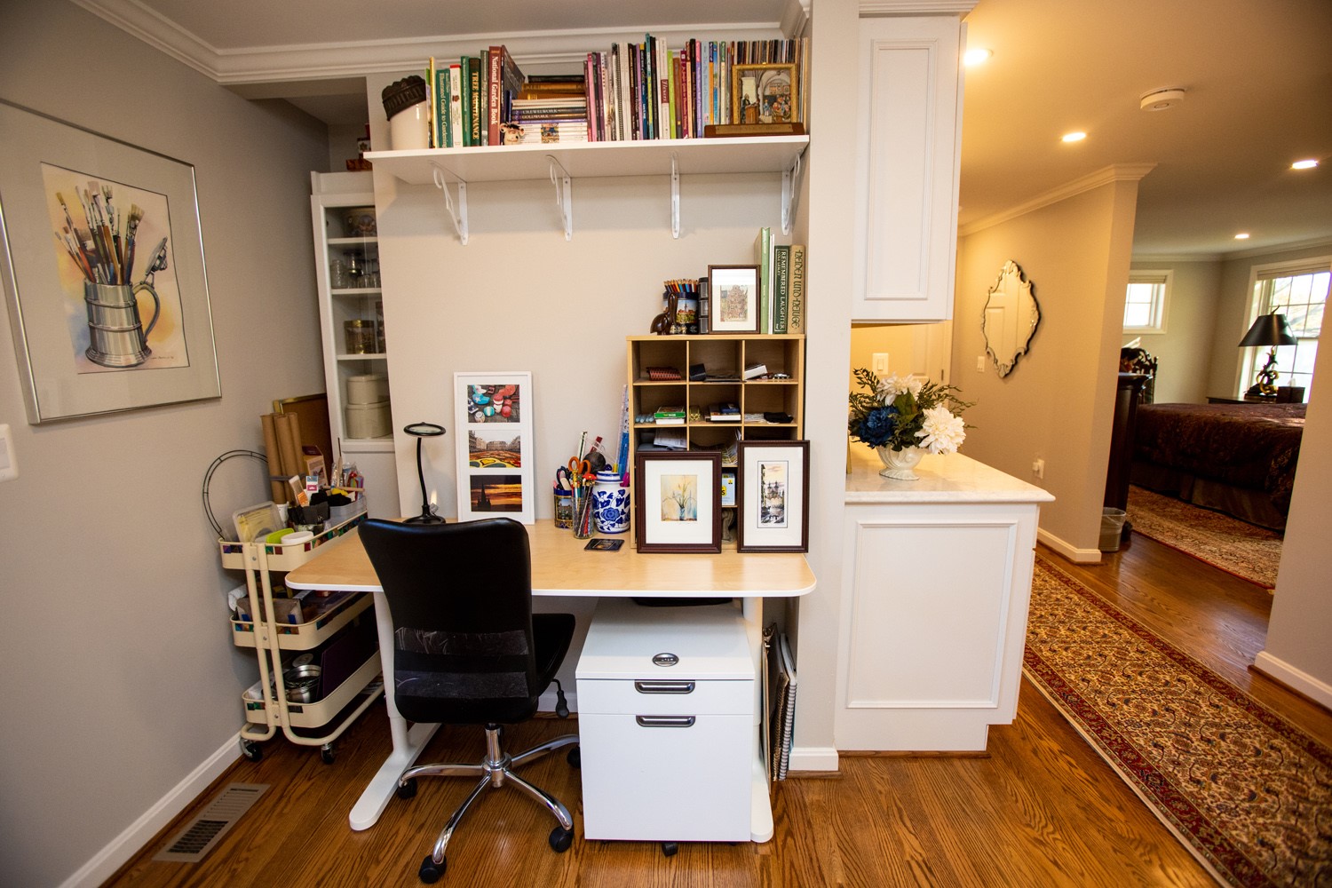 A home office with a desk and bookshelves.