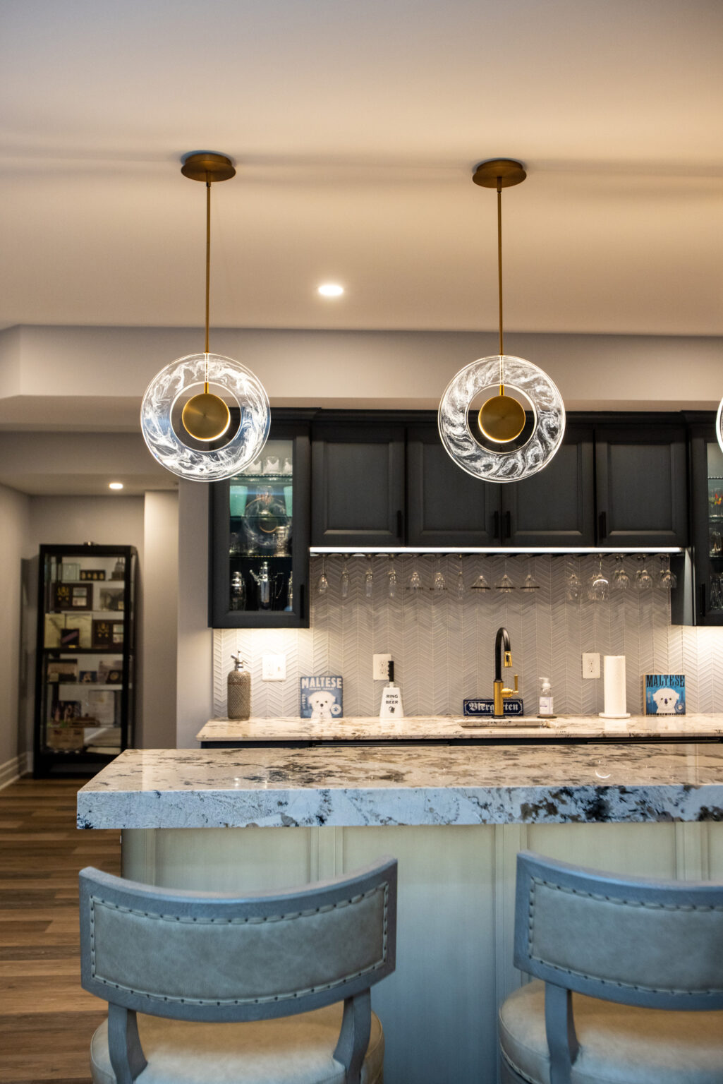 Gorgeous and interesting pendent lights hang over the bar.