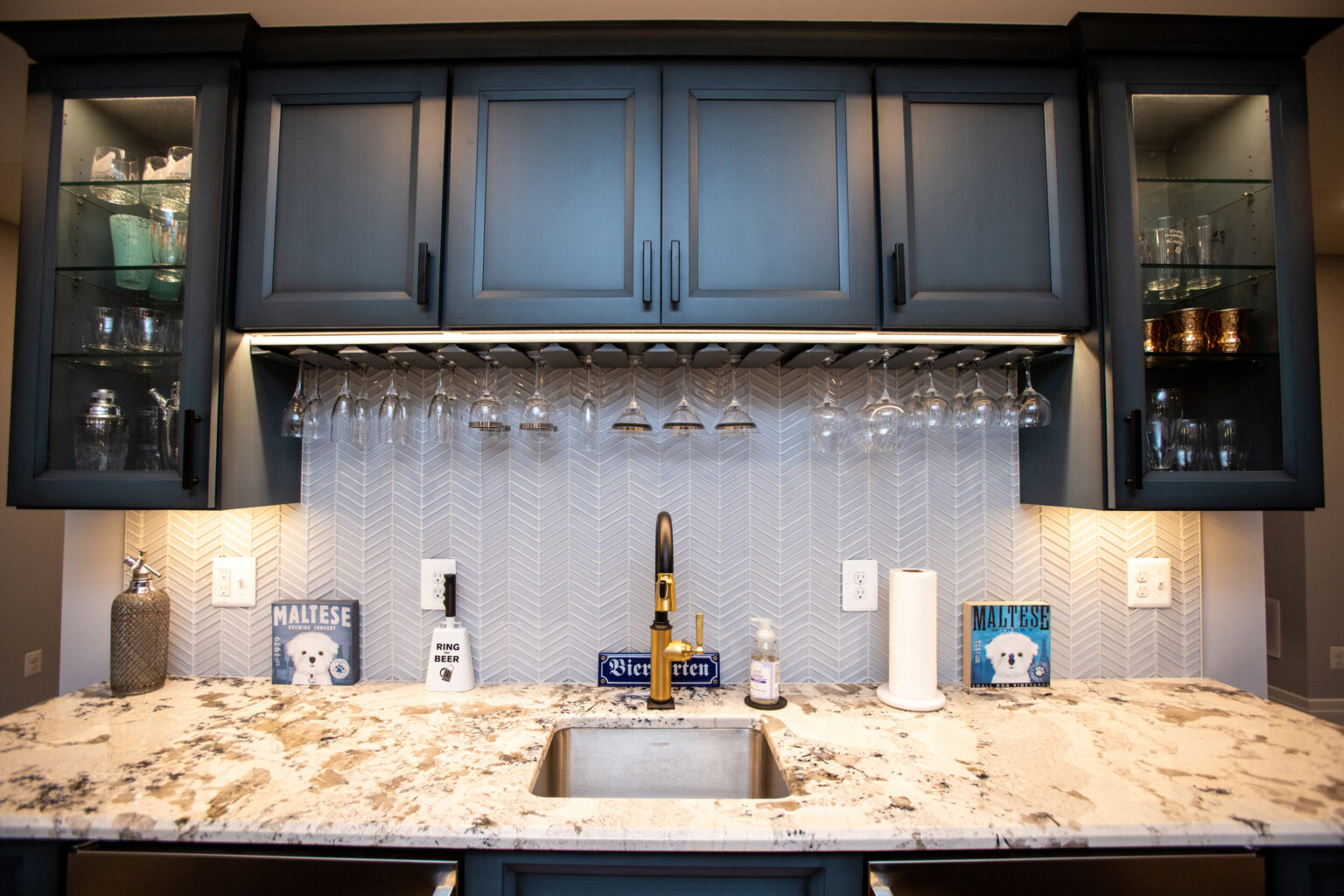 Cabinetry features glass front doors and stemware racks.