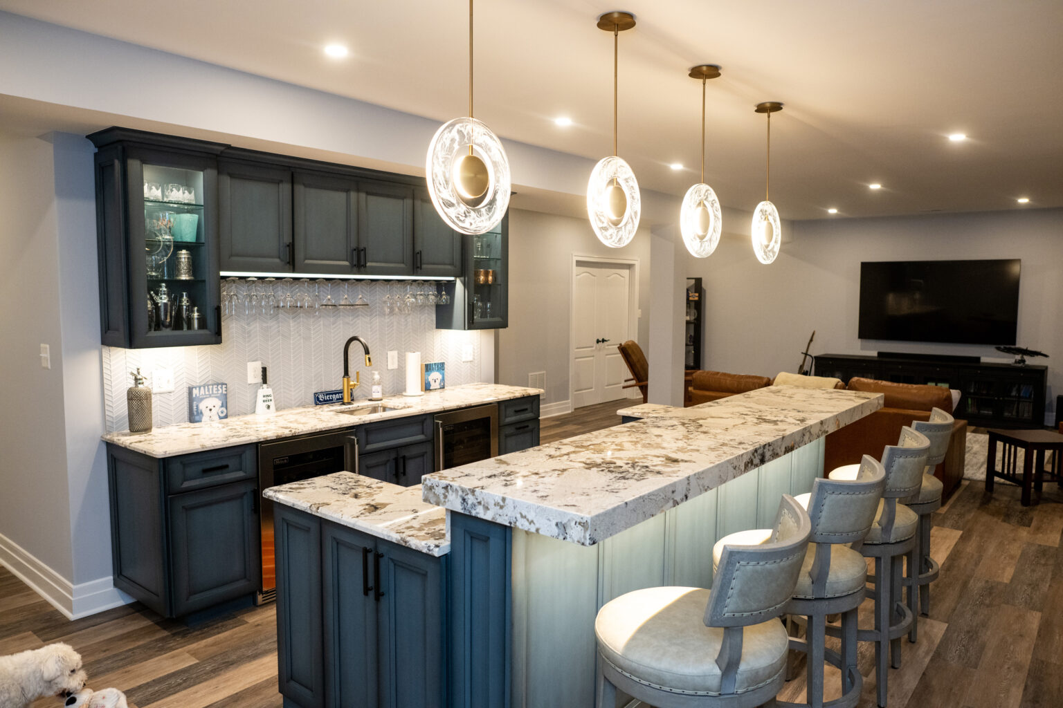 Basement bar with pendent lights.