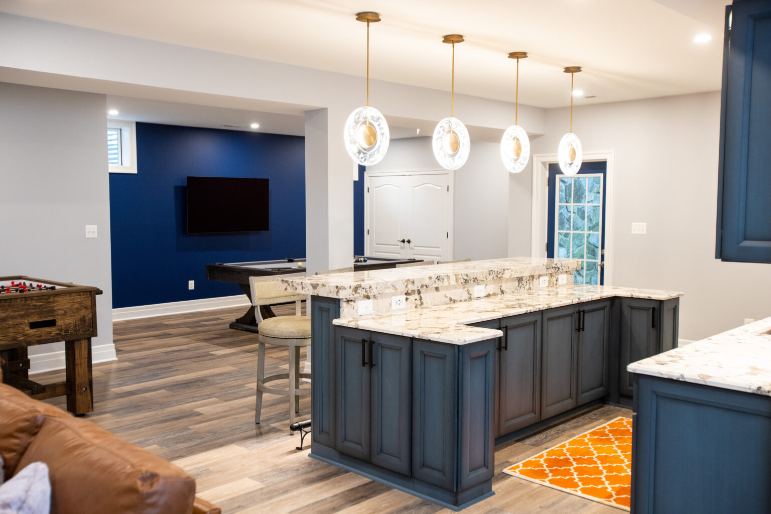 Basement bar with gorgeous island lights.