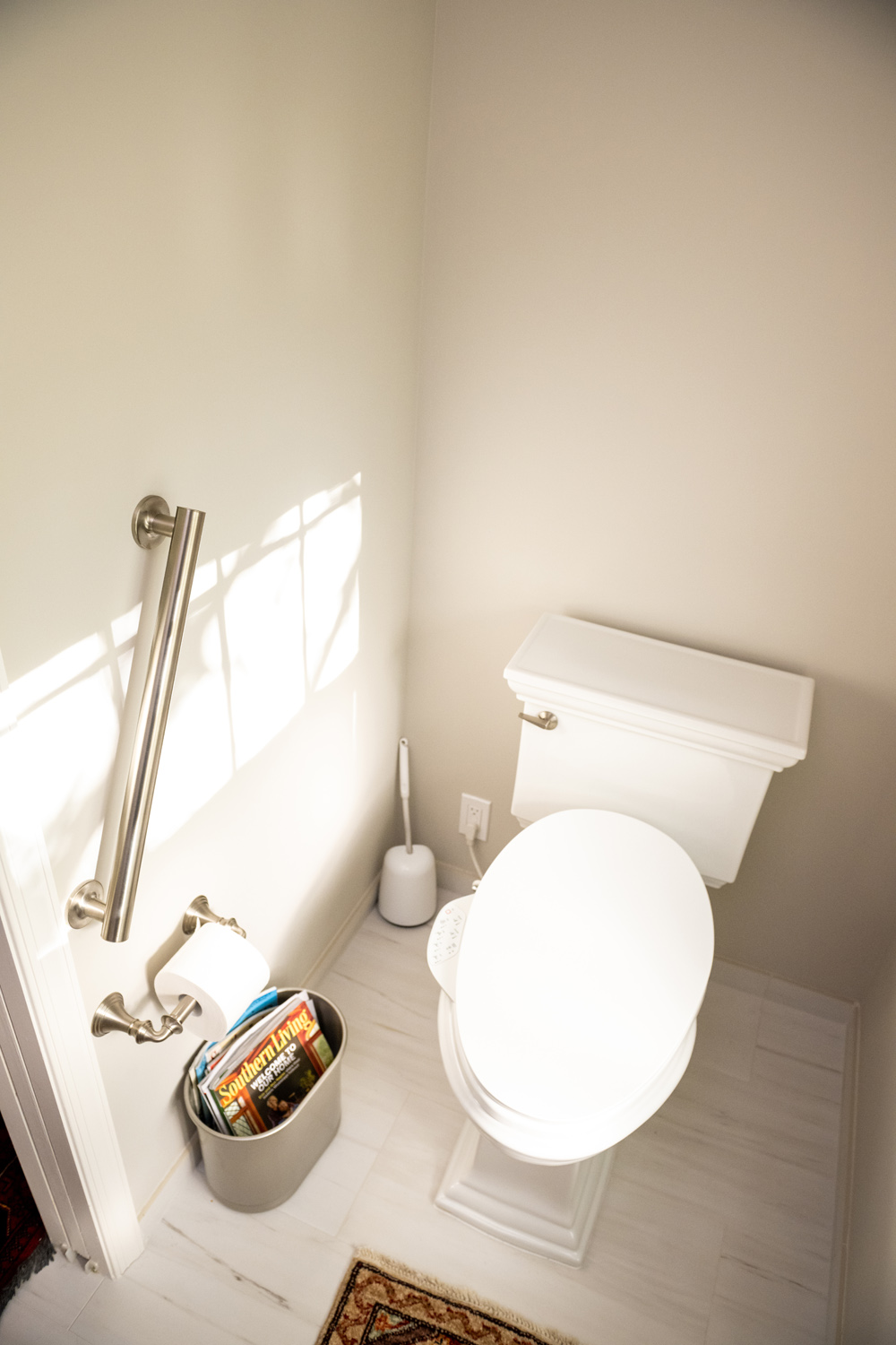 Image by Lesnick Photo A water closet with a toilet, bidet and grab bar.