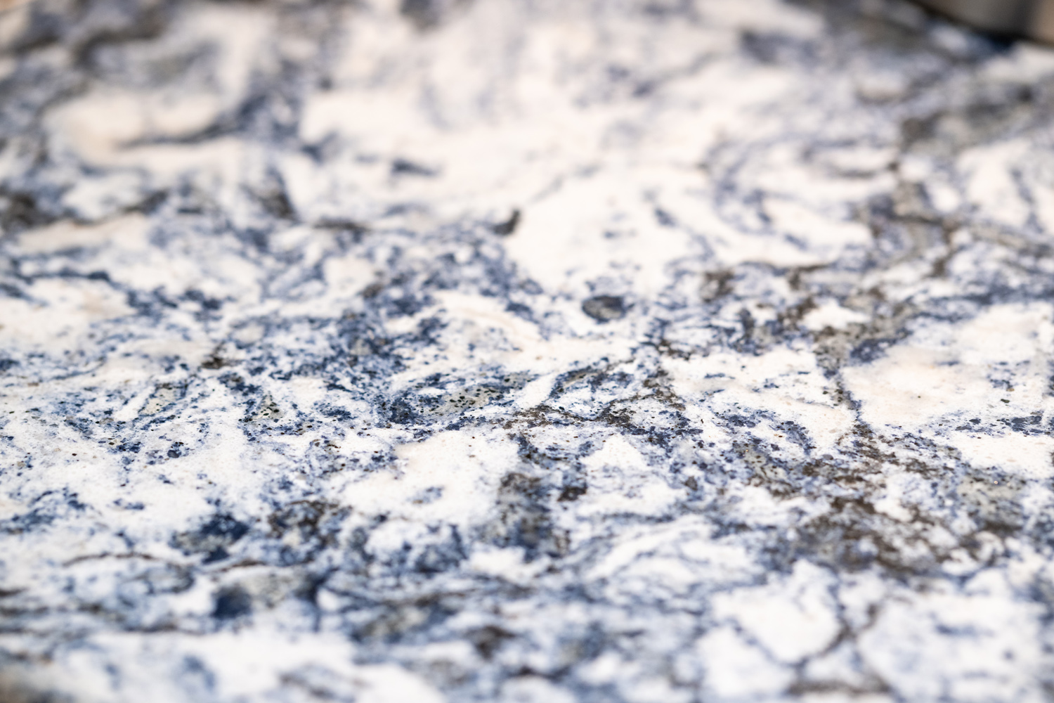 Close-up of a blue and white granite countertop surface with a marbled, textured pattern.