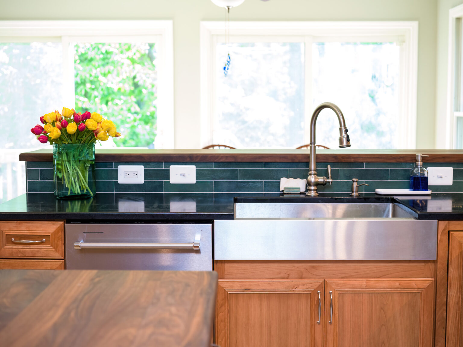Image by Lesnick Photo stainless steel farmhouse sink with stainless steel dishwasher.