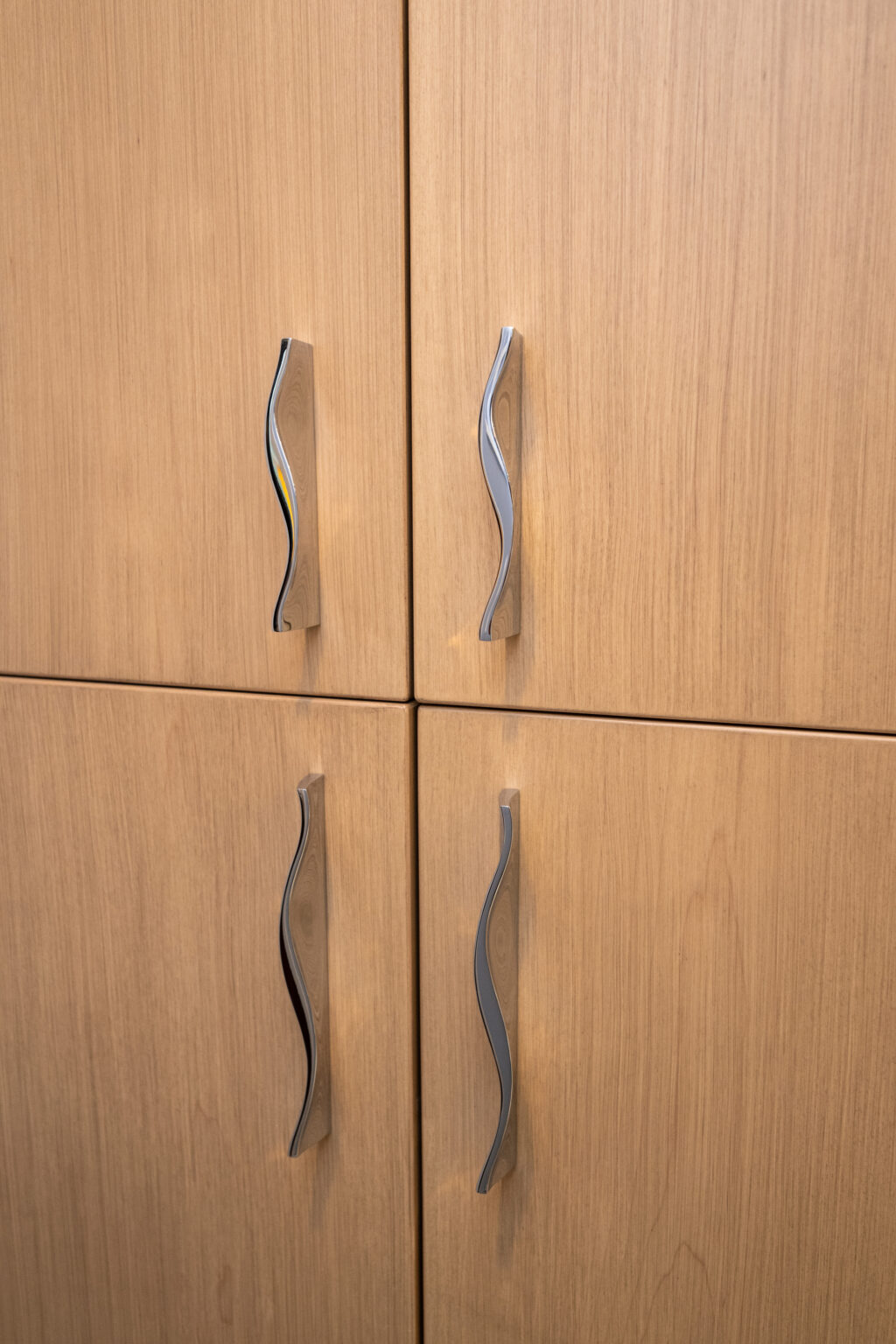 Image by Lesnick Photo Four wooden cabinet doors with curved metal handles.