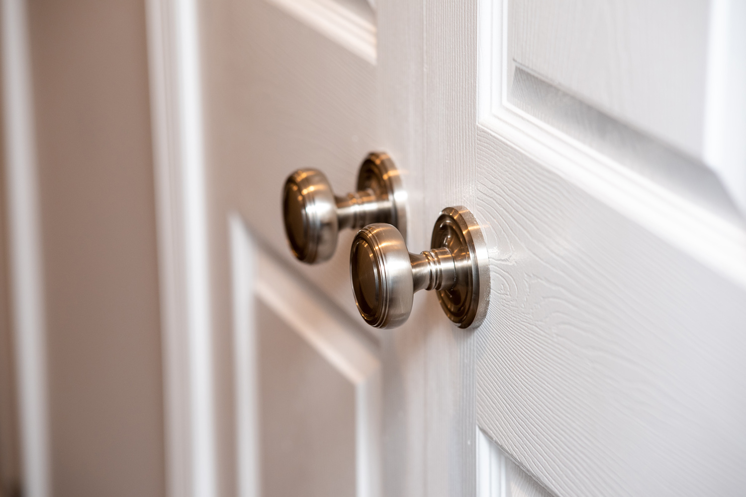 Double doors with metallic round doorknobs.