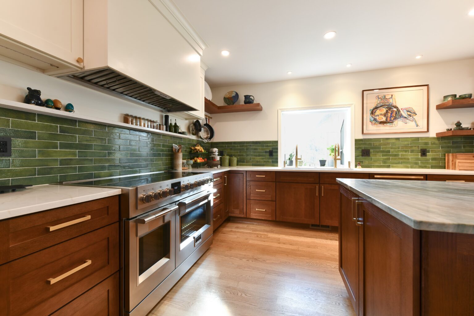 Modern kitchen with wood cabinets, green tile backsplash, stainless steel appliances, open shelves, and a large window letting in natural light.